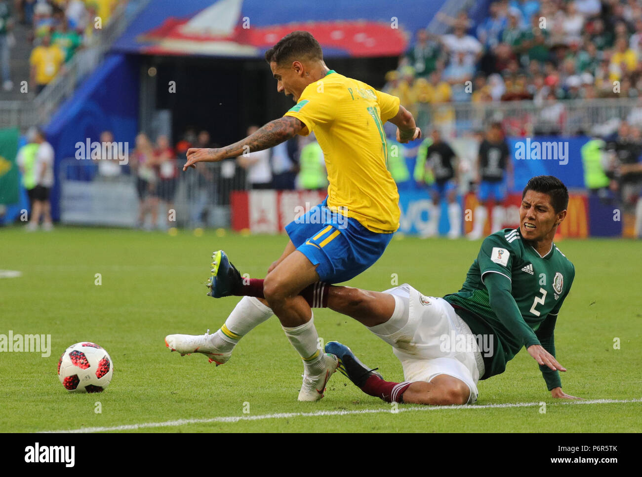 Samara, Russia. 02nd July, 2018. Soccer, World Cup 2018, Final round - round of 16: Mexico vs. Brazil at the Samara stadium: Brazil's Philippe Coutinho and Mexico's Hugo Ayala Castro (R) vying for the ball. Credit: Christian Charisius/dpa/Alamy Live News Stock Photo
