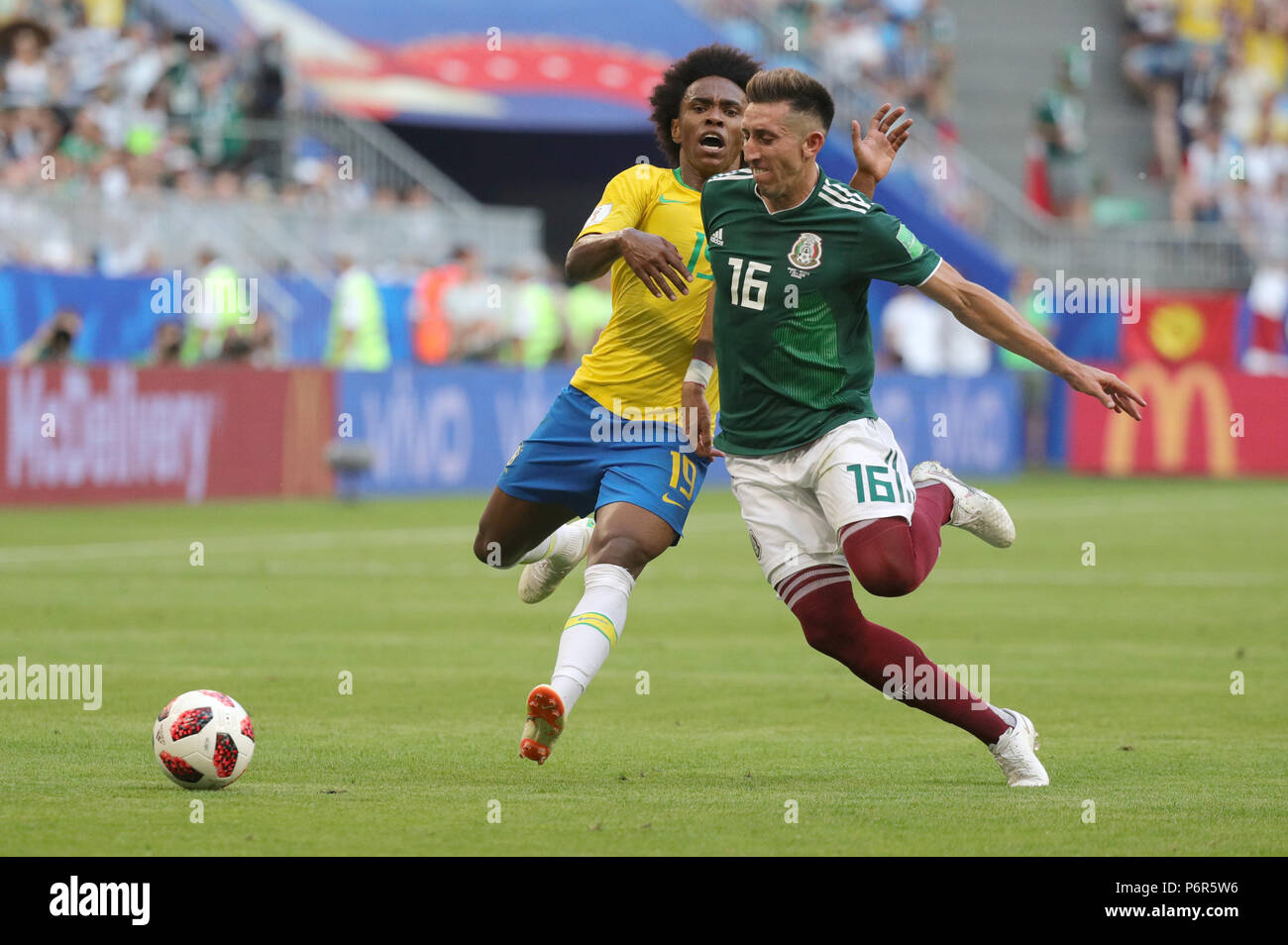 Samara, Russia. 02nd July, 2018. Soccer, World Cup 2018, Final round - round of 16: Mexico vs. Brazil at the Samara stadium: Brazil's Willian and Mexico's Hector Herrera vying for the ball. Credit: Christian Charisius/dpa/Alamy Live News Stock Photo