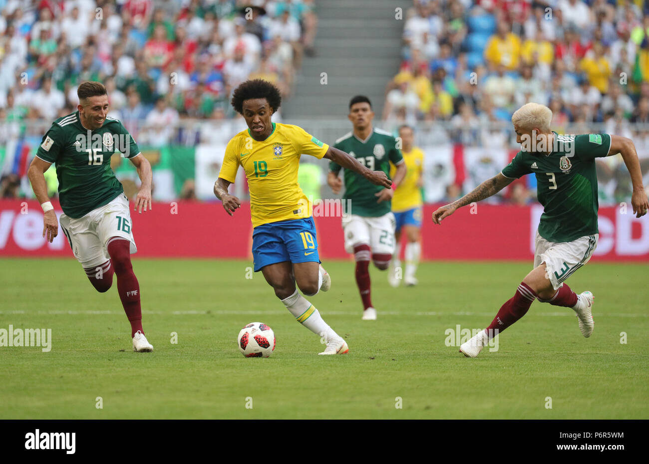Samara, Russia. 02nd July, 2018. Soccer, World Cup 2018, Final round - round of 16: Mexico vs. Brazil at the Samara stadium: Brazil's Willian (C) and Mexico's Hector Herrera (L) and Carlos Salcedo vying for the ball. Credit: Christian Charisius/dpa/Alamy Live News Stock Photo
