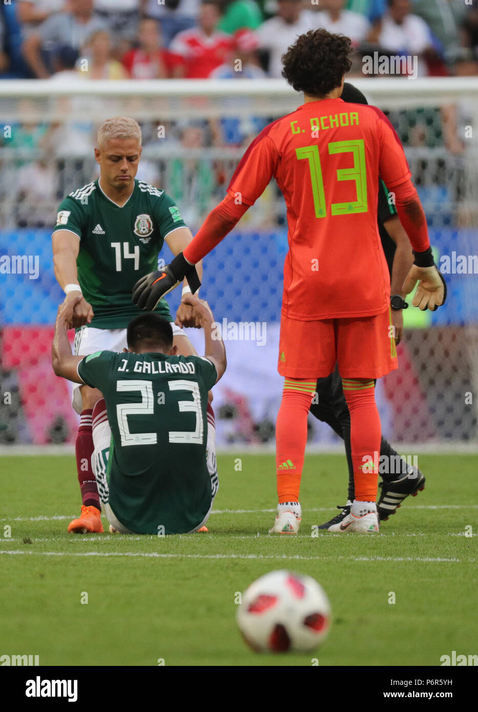 Samara, Russia. 02nd July, 2018. Soccer, World Cup 2018, Final round - round of 16: Mexico vs. Brazil at the Samara stadium: Mexico's Jesus Gallardo sitting in the field after the defeat next to teammate Chicharito (Javier Hernandez, top) and goalkeepoer Guillermo Ochoa (R). Credit: Christian Charisius/dpa/Alamy Live News Stock Photo
