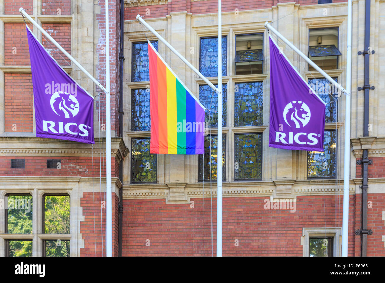 Westminster, London, UK, 2nd July 2018. A pride flag displayed at the HQ of RICS, the Royal Institute of Chartered Surveyors. Pride flags in rainbow colours are displayed on top of many government and civil buildings and sights in the heart of the capital ahead of Pride in London events and the Pride March on July 7th. Credit: Imageplotter News and Sports/Alamy Live News Stock Photo