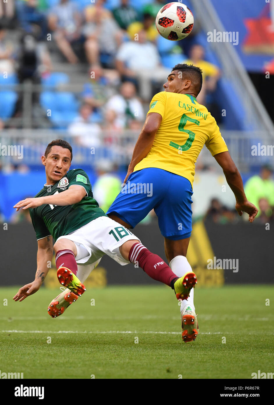 Samara, Russia. 2nd July, 2018. Casemiro (R) of Brazil vies with Andres Guardado of Mexico during the 2018 FIFA World Cup round of 16 match between Brazil and Mexico in Samara, Russia, July 2, 2018. Brazil won 2-0 and advanced to the quarter-final. Credit: Li Ga/Xinhua/Alamy Live News Stock Photo
