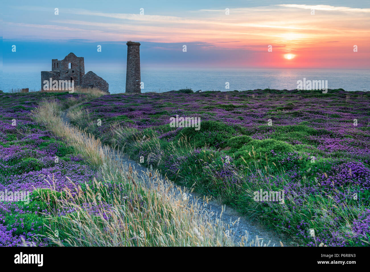Wheal Coates, Cornwall. 2nd July, 2018. UK Weather - After another warm and humid  day the high cloud breaks to give a spectacular  sunset over the heather and gorse at Wheal Coates, deep in the heart of the 'Poldark' county of North Cornwall. Credit: Terry Mathews/Alamy Live News Stock Photo