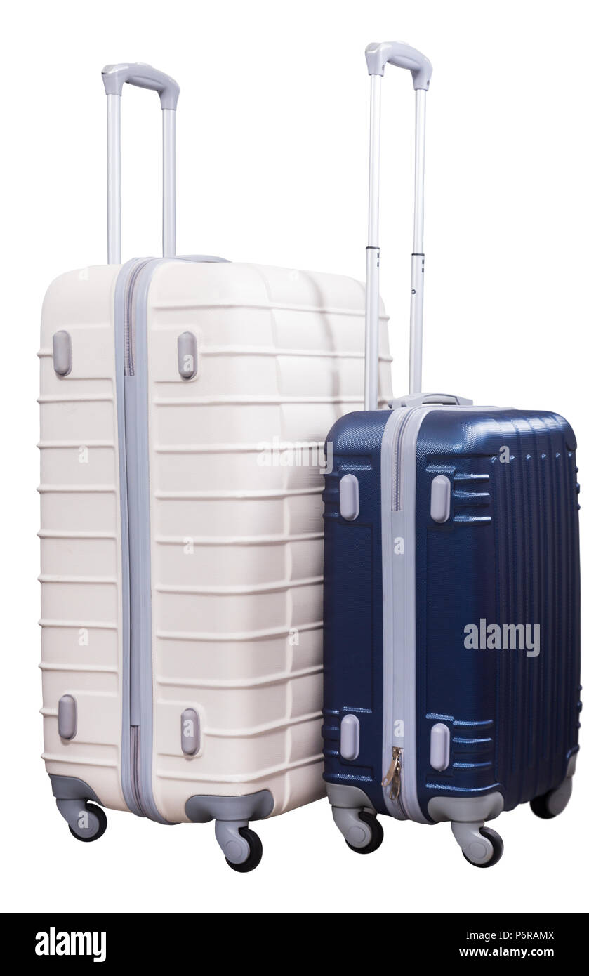 Two suitcases on wheels of different colors standing together Stock