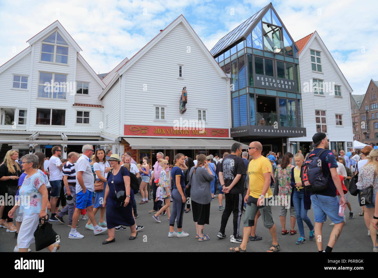 People walk past Zachariasbryggen in Bergen city centre, Norway Stock Photo