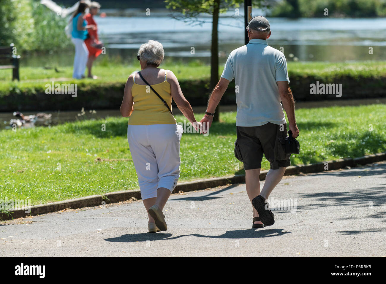 Couple holding hands walking hi-res stock photography and images - Alamy