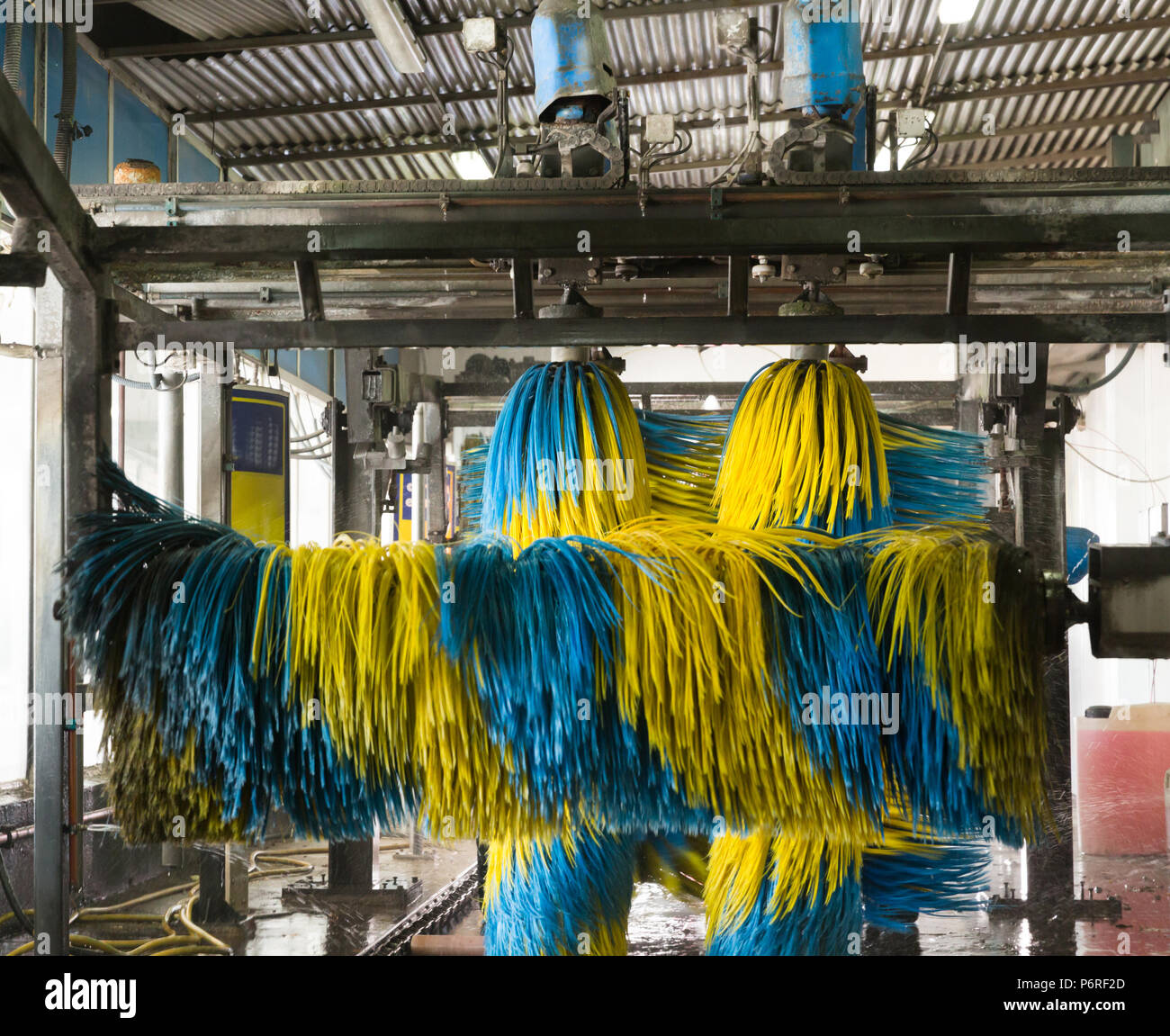 Inside view of equipment of automatic car wash with colored brushes