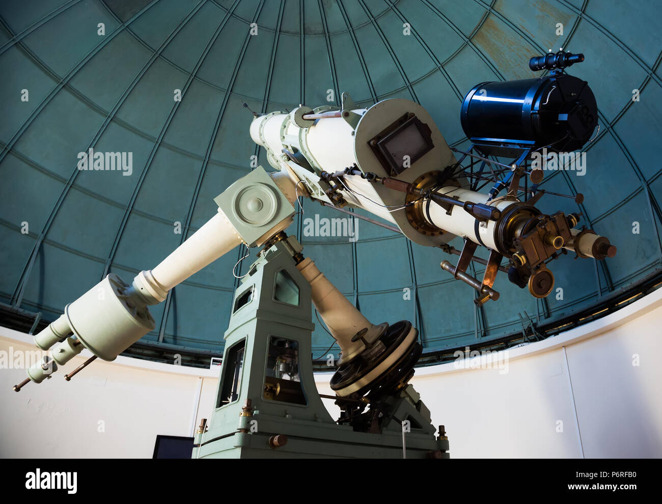 modern large telescope in observatory with windows closed Stock