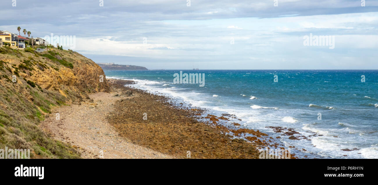 Houses on the cliffs overlooking Marino Rocks Beach and St Vinvent Gulf