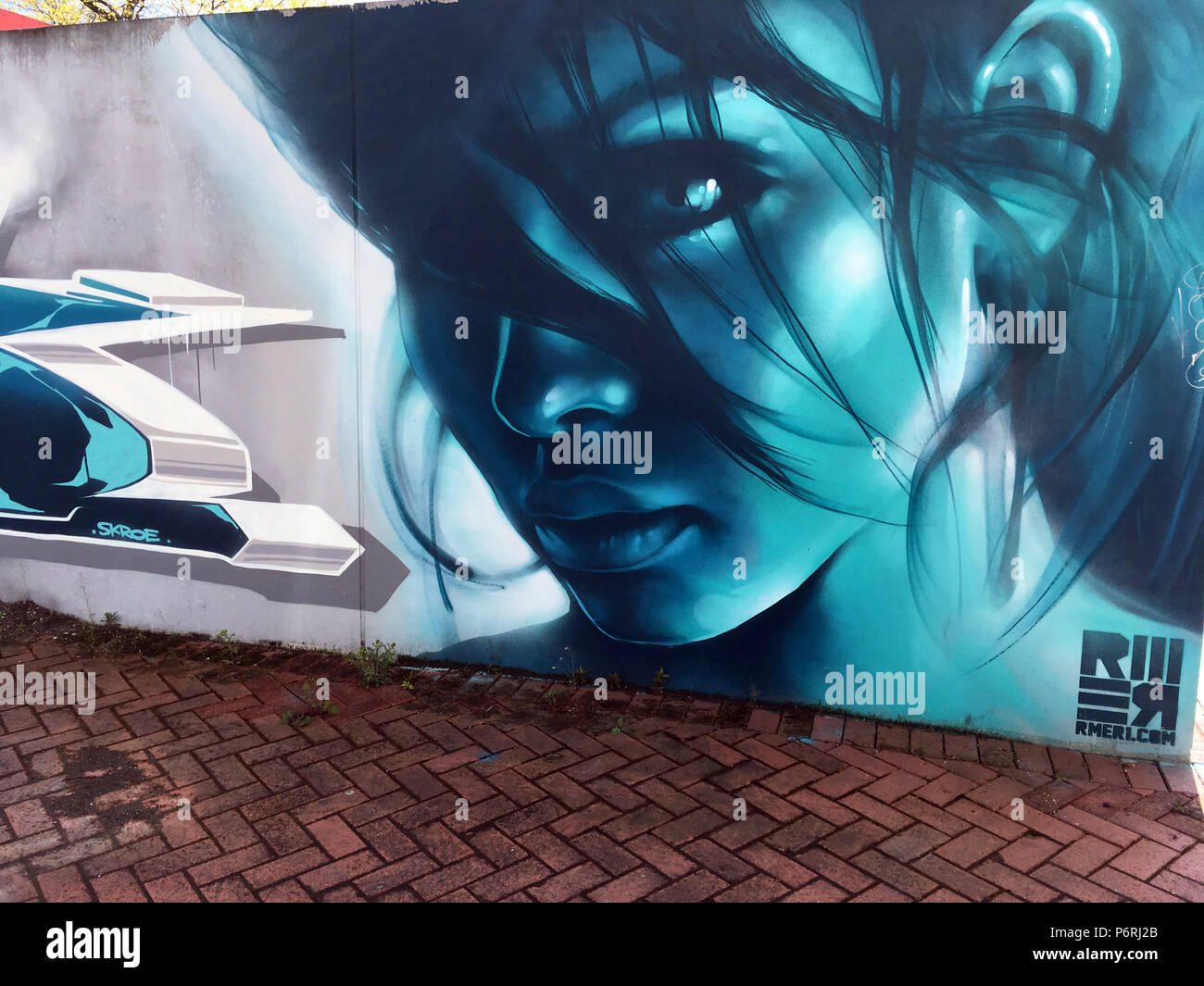 beautiful blue female face sprayed on a wall Stock Photo - Alamy
