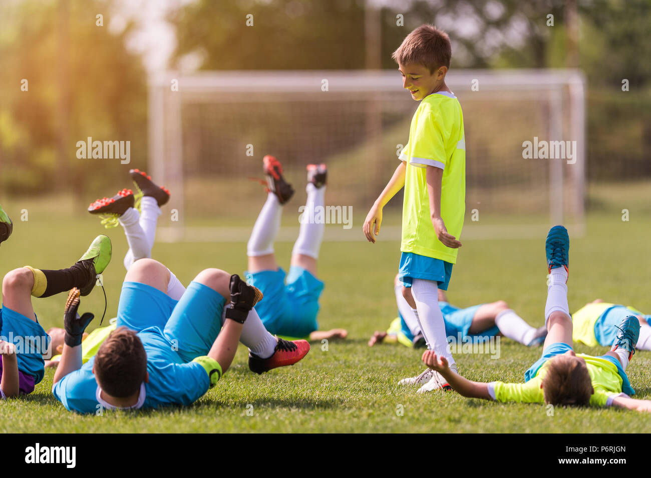 Kids soccer football - young children players celebrating after victory Stock Photo