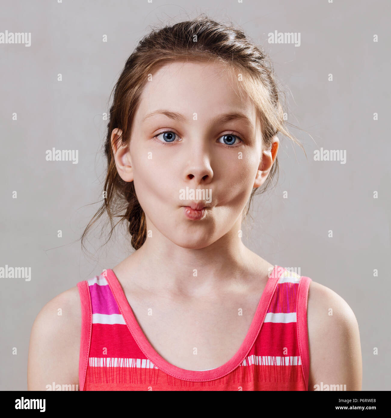 Portrait of little girl with funny fish expression. Stock Photo