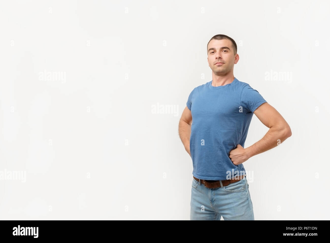 Handsome young man standing like a super hero Stock Photo