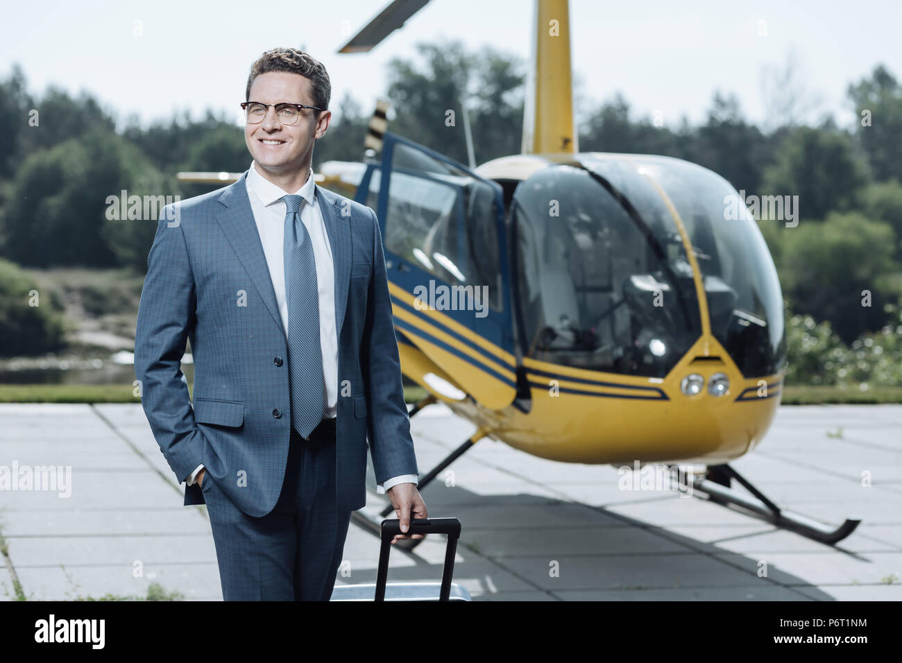 Successful young CEO being proud of helicopter purchase Stock Photo
