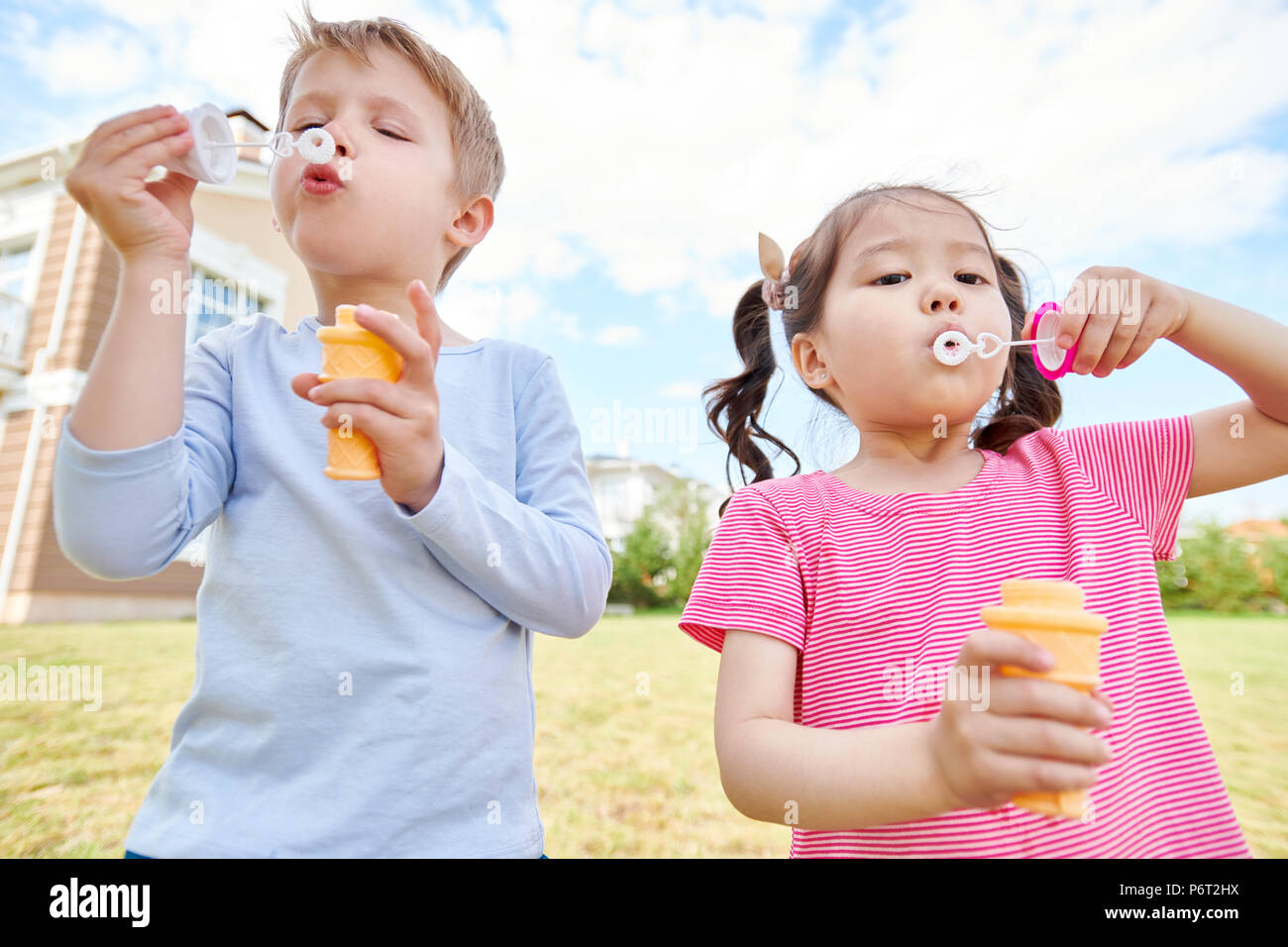 Happy Children Blowing Bubbles Stock Photo Alamy