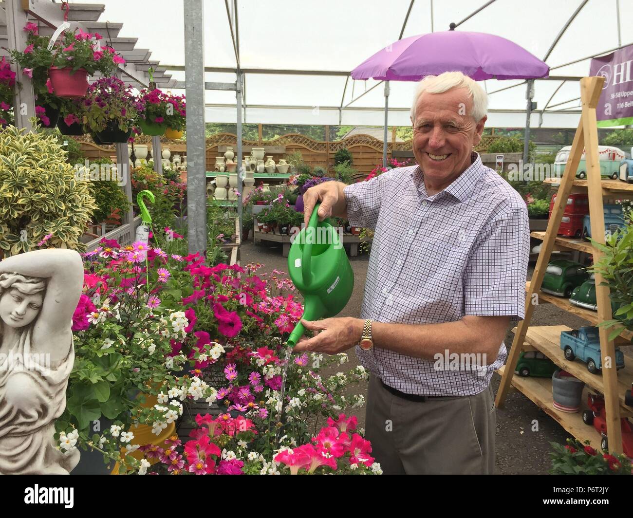 Owner of hillmount garden centre robin mercer watering flowers hires