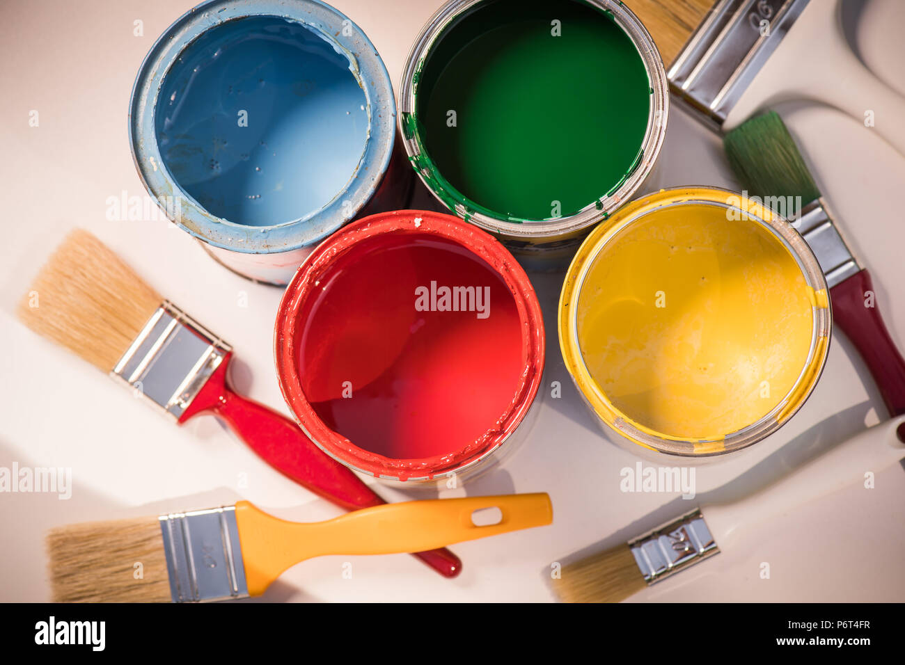 Paint brushes and opened paint cans with colors Stock Photo Alamy