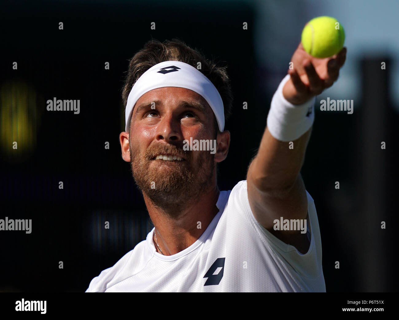 Norbert Gombos in action against Kevin Anderson on day one of the Wimbledon  Championships at the All England Lawn tennis and Croquet Club, Wimbledon  Stock Photo - Alamy