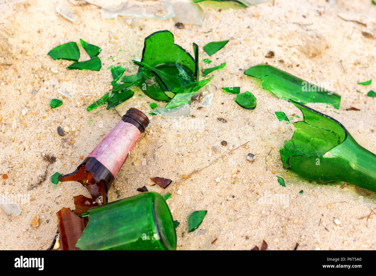 Broken beer glass bottles on a sand Stock Photo Alamy
