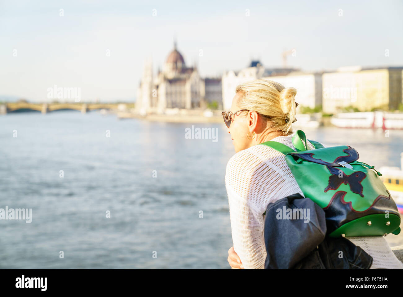 A woman tourist is enjoying view of and the Danube River in Budapest, Hungary Stock Photo