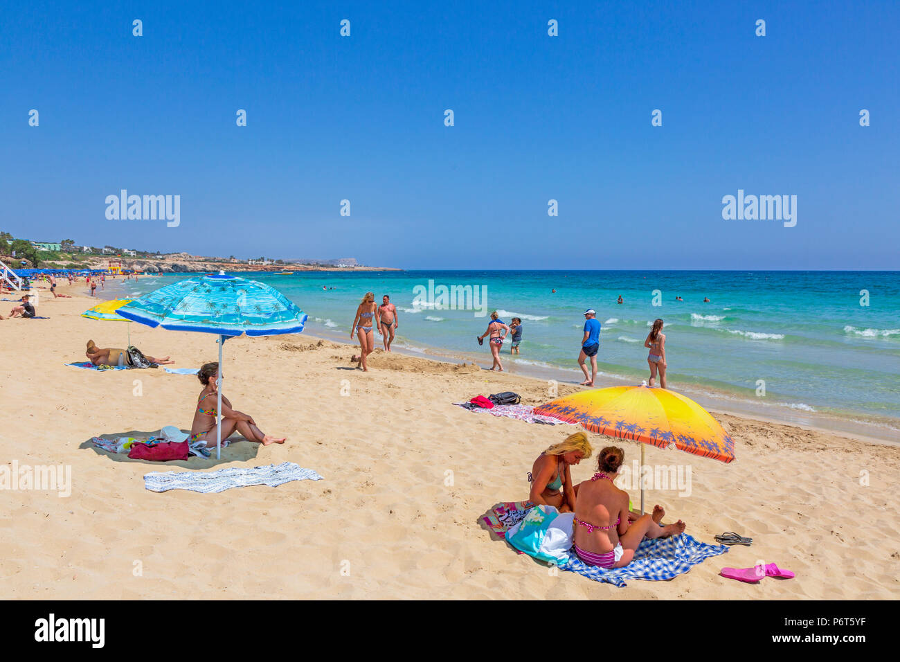 Tourists sunbathing on Karousos Beach, Ayia Napa, Cyprus Stock Photo