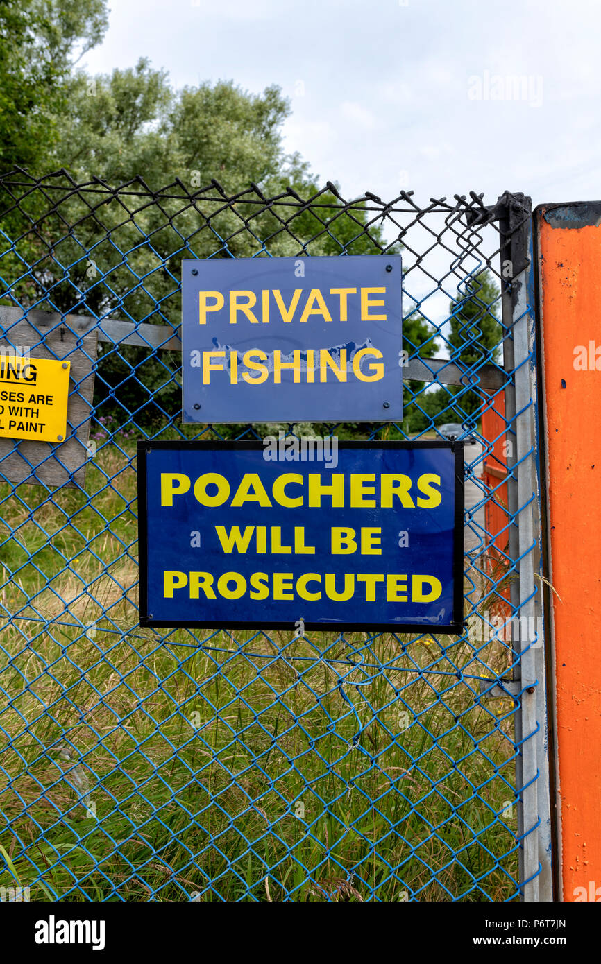 Warning signs on the entrance to a private fishing lake. Private fishing. Poachers will be prosecuted Stock Photo
