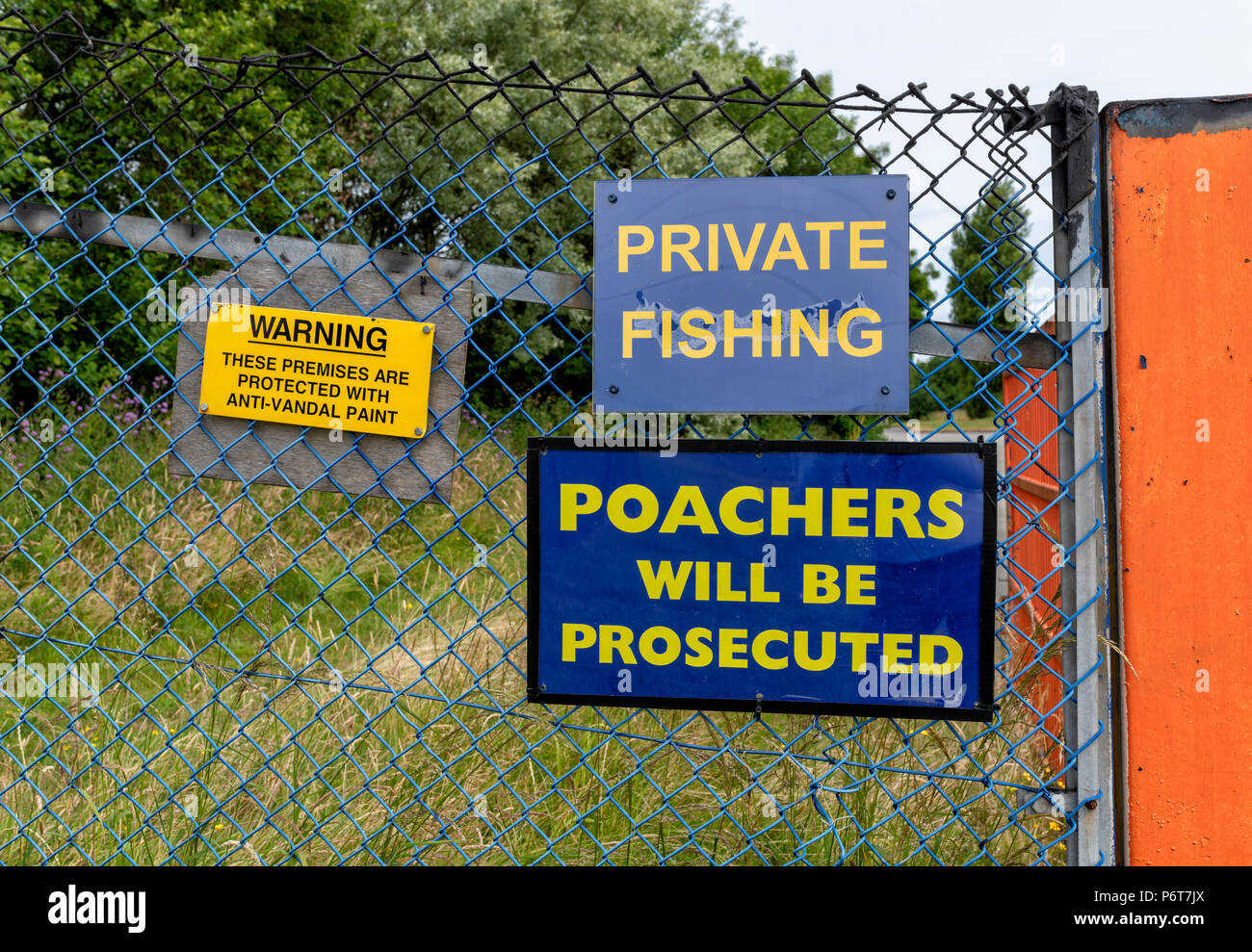 Warning signs on the entrance to a private fishing lake. Private fishing. Poachers will be prosecuted Stock Photo