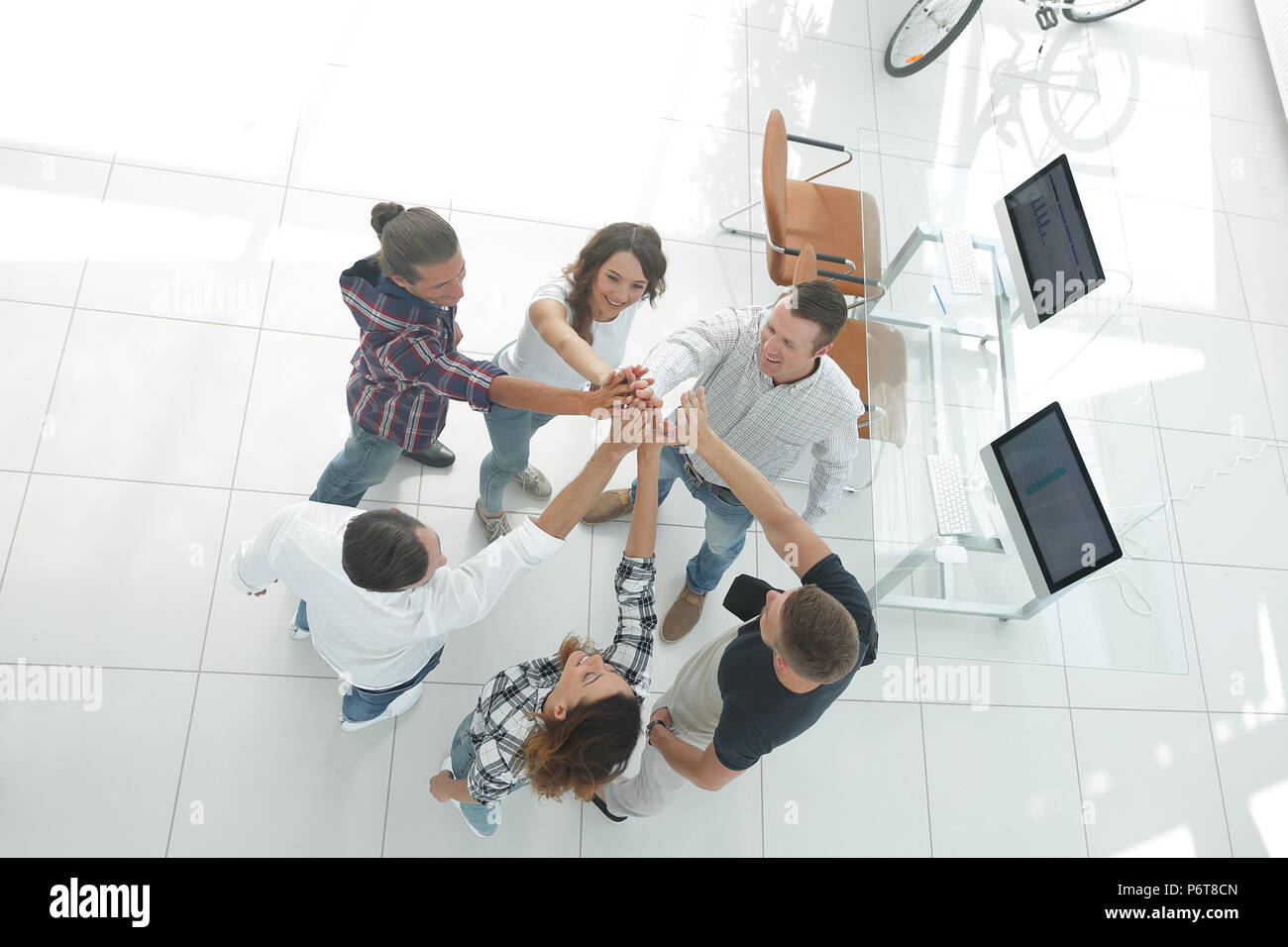 creative team giving each other a high five Stock Photo