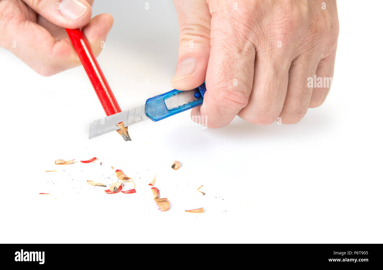 Carpenter pencil sharpen with cutter knife on white Stock Photo