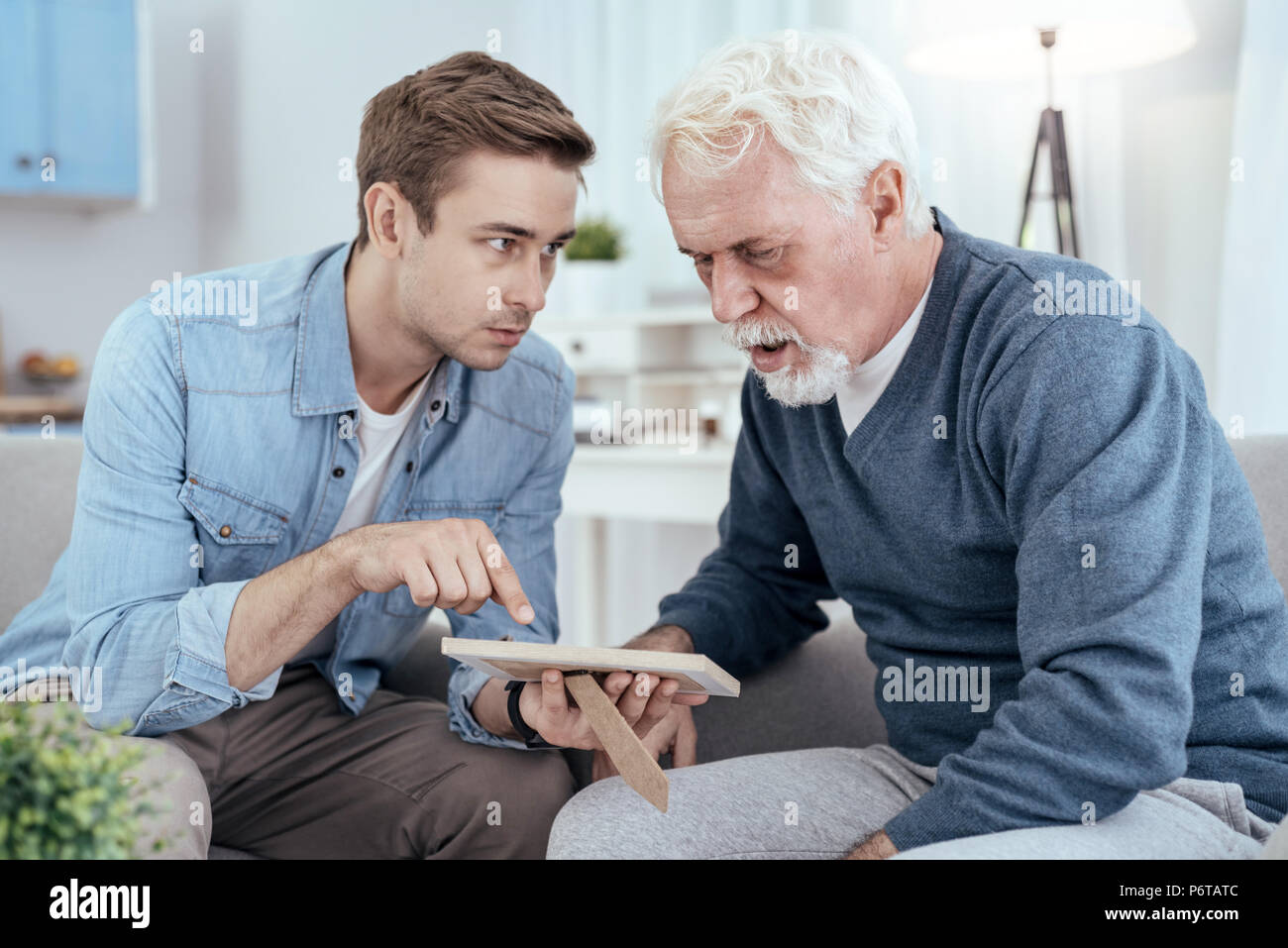 Astonished senior man reminiscing past Stock Photo