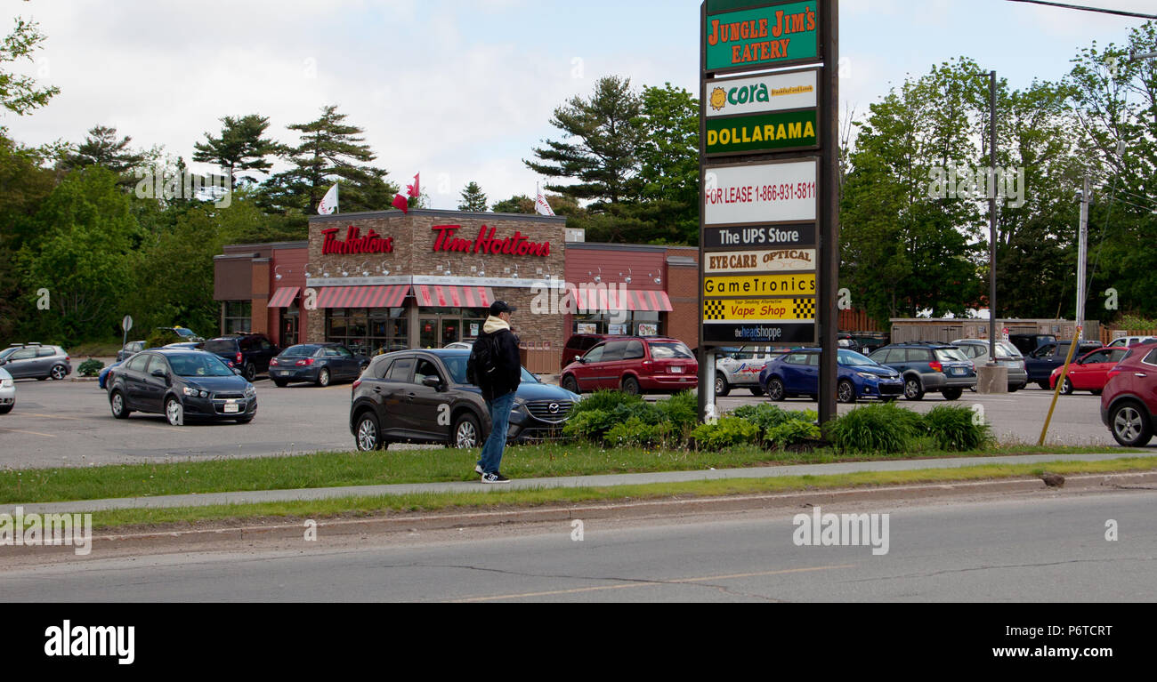 June 3, 2018- Commercial Street, New Minas, Nova Scotia: A busy Tim Hortons franchise on Commercial Street with sign for a plaza including Jungle Jims Stock Photo