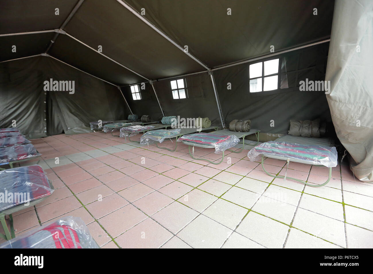 Tent shelter with temporary beds ready for natural disaster refuges ...