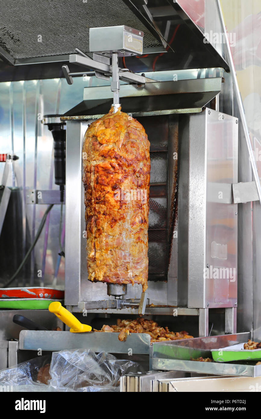Kebab gyro meat roasted on a vertical spit Stock Photo - Alamy