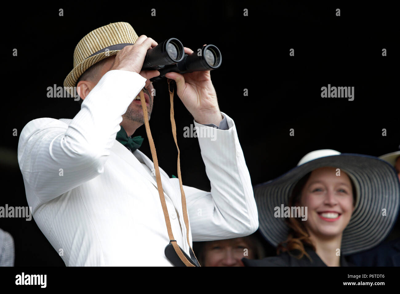 Dresden, racetrack visitor looks through his binoculars Stock Photo