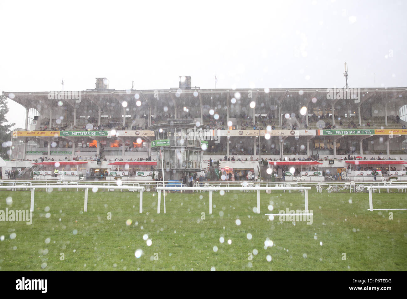Hamburg, heavy rain shower goes down over the racecourse Stock Photo