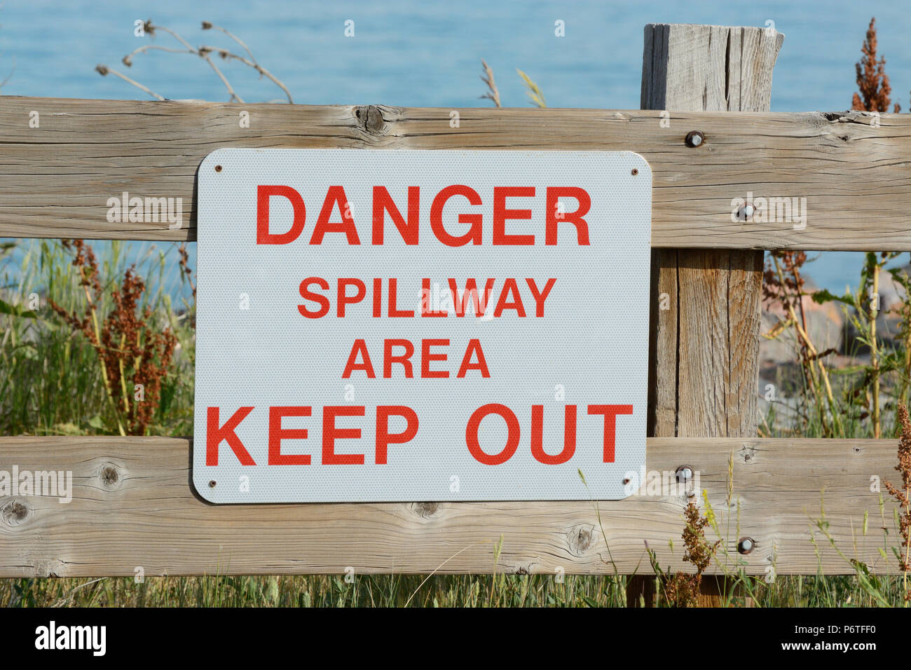 Danger dam spillway sign on wooden fence dam at Standley Lake in Westminster Colorado Stock Photo