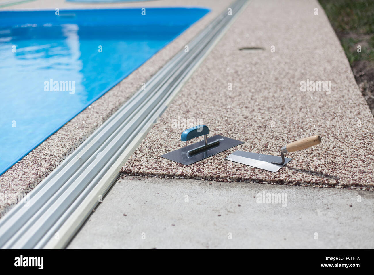 Coloured Concrete Around Pool with tools Stock Photo