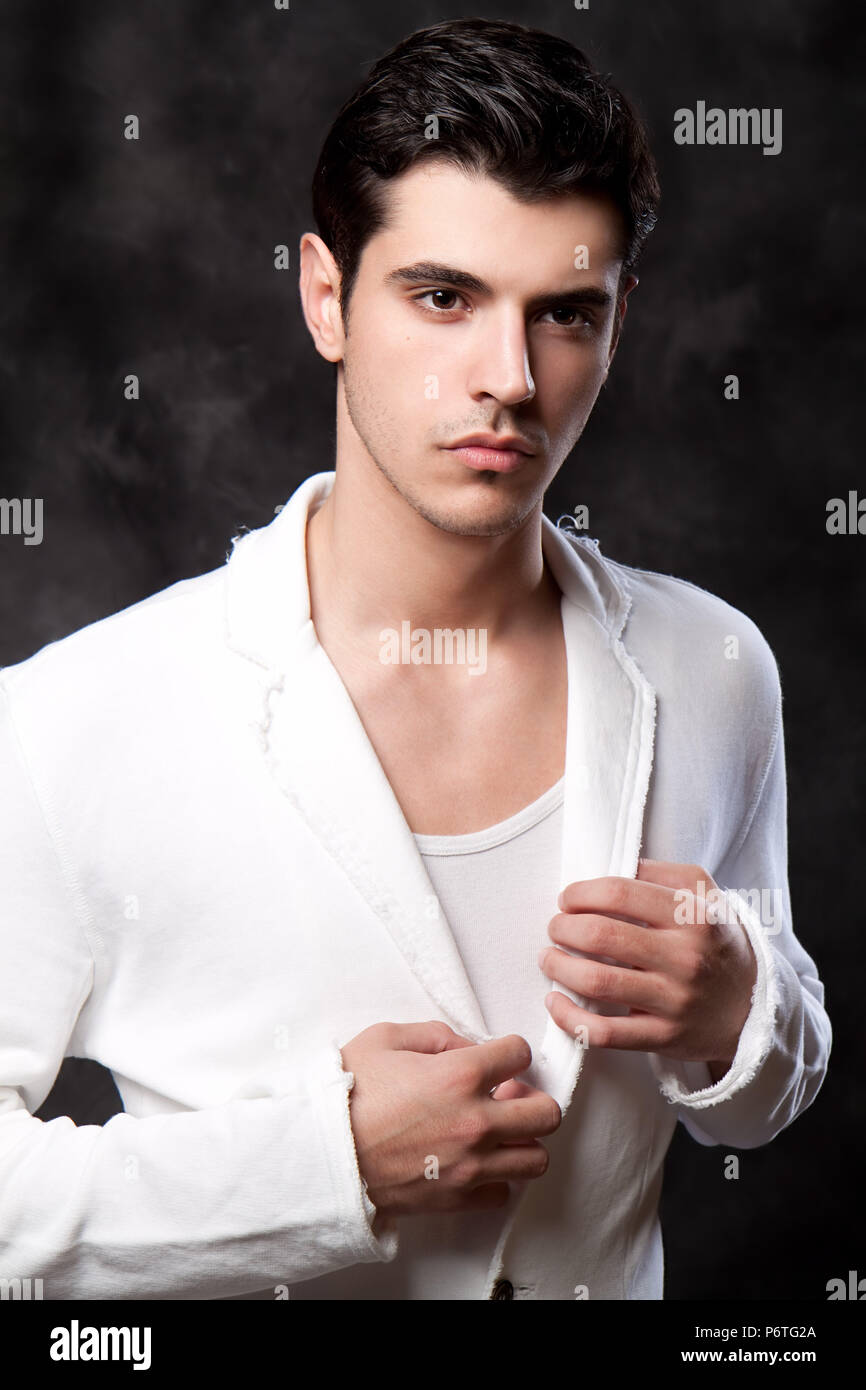 Handsome young man posing in white jacket Stock Photo