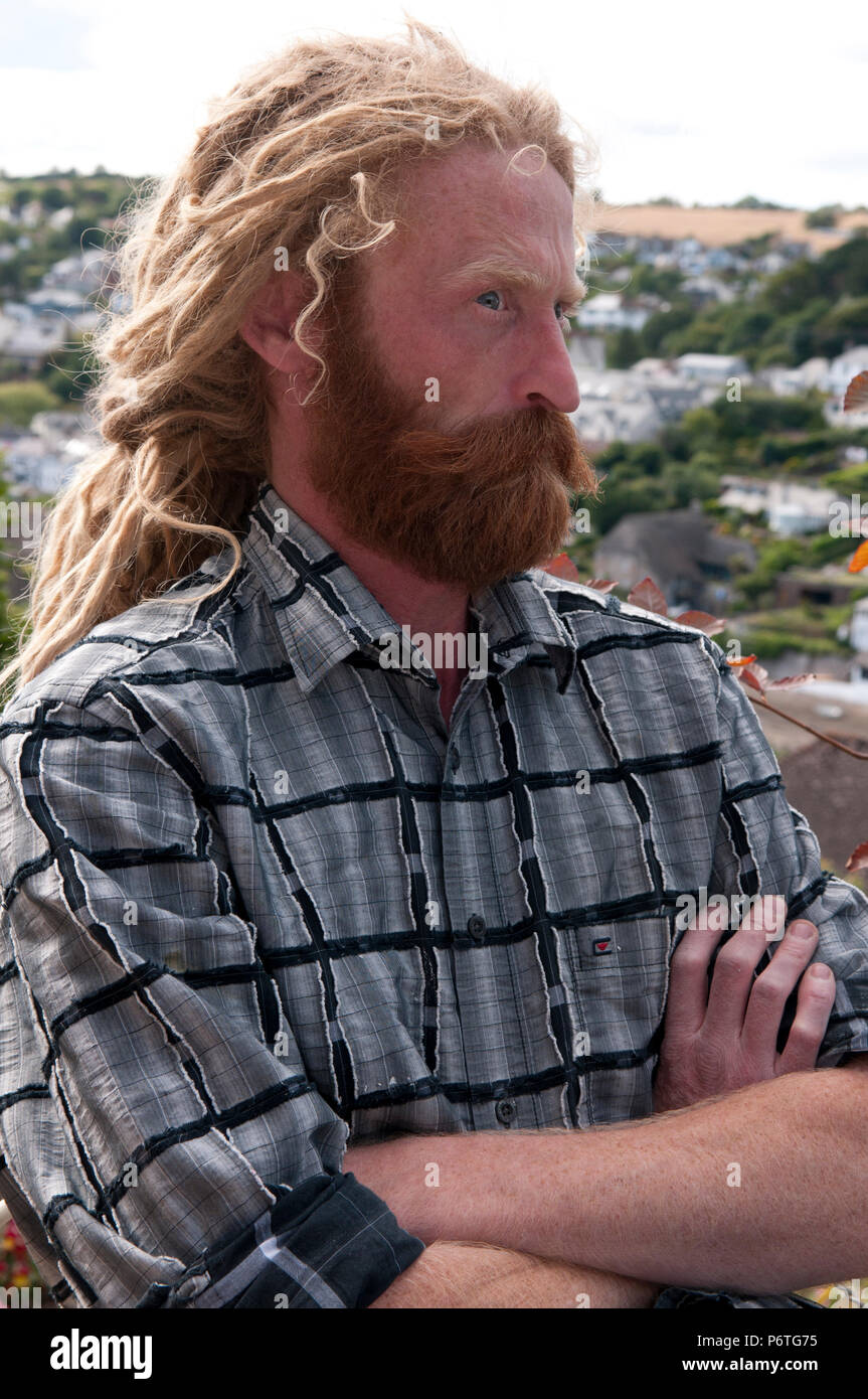 Portrait of man with long blonde dreadlocks and ginger beard and moustache Stock Photo