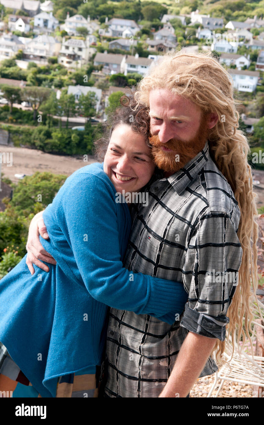 Happy couple cuddling smiling laughing Stock Photo