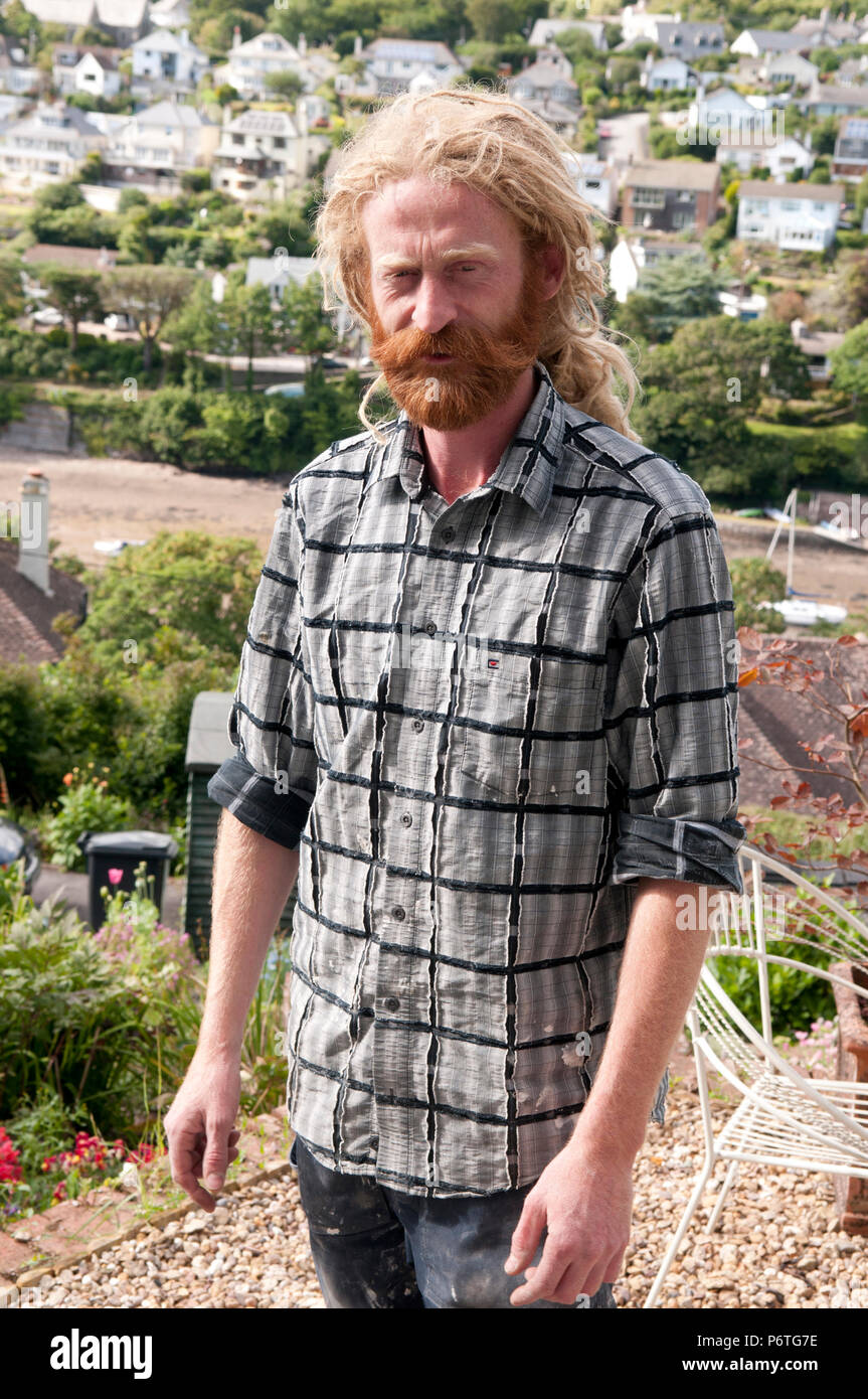 Portrait of man with long blonde dreadlocks and ginger beard and moustache Stock Photo
