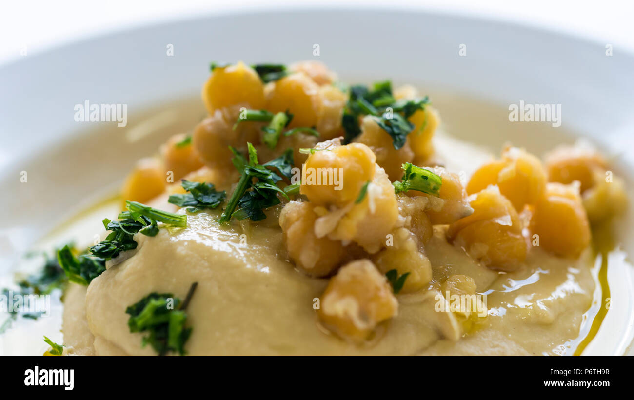 Hummus plate with parsley Stock Photo Alamy