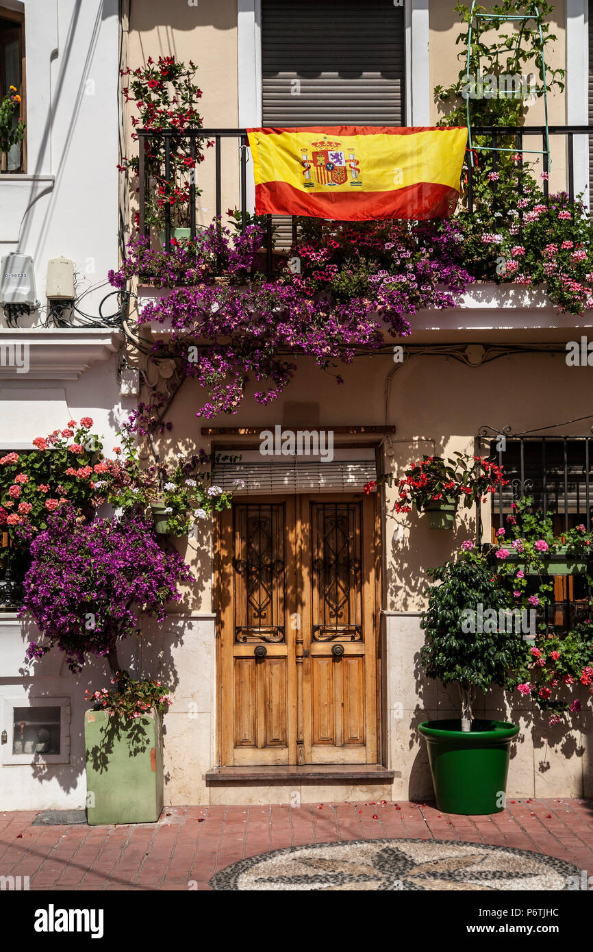 floral display & white washed housing in Estepona, Spain Stock Photo