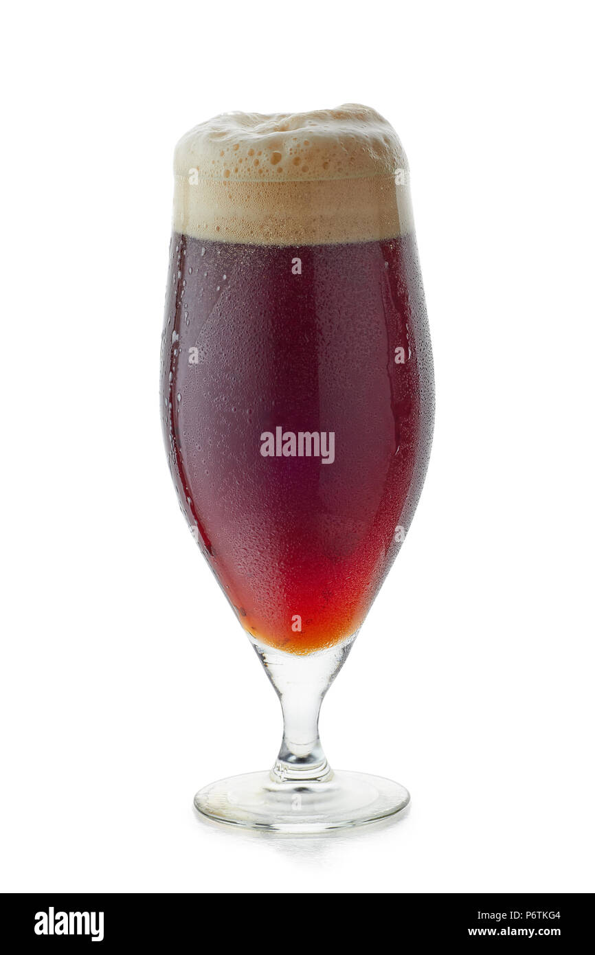 Glass of dark beer with foam on white Stock Photo