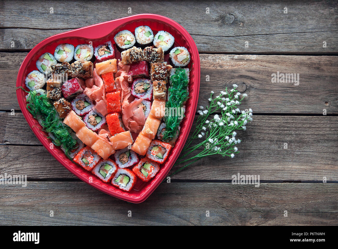 Sushi on a old wooden table background with a heart shaped decor Stock Photo