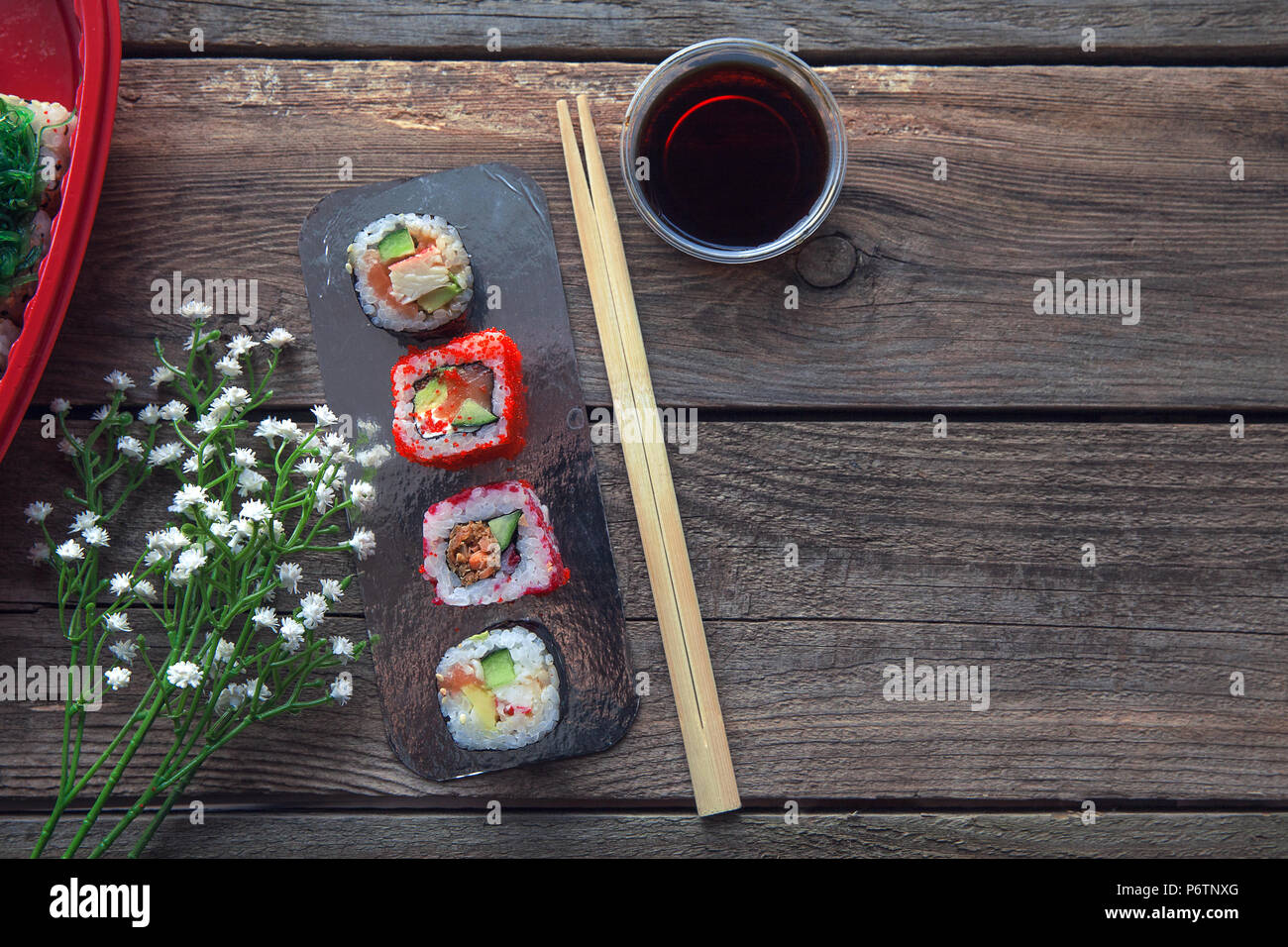 Sushi on a old wooden table background with a decoration Stock Photo