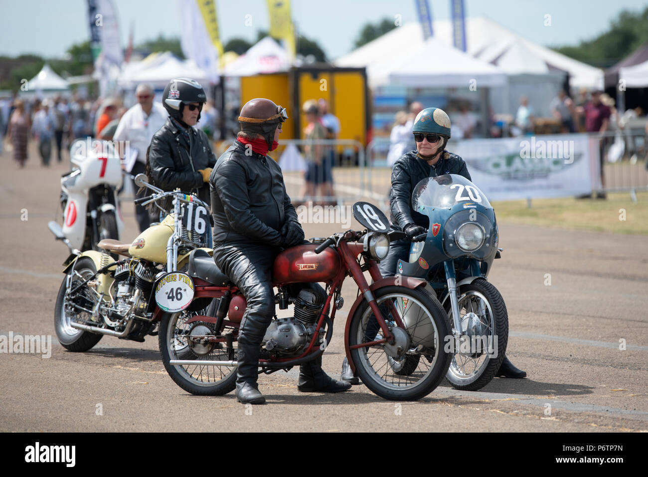 Man and woman riding vintage motorcycles at the flywheel festival. Bicester Heritage Centre. Oxfordshire, England. Stock Photo