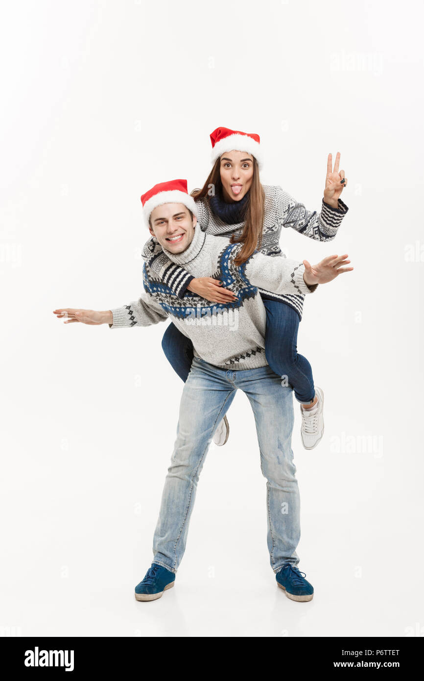 Young couple enjoying piggyback ride isolated on gray background Stock  Photo - Alamy