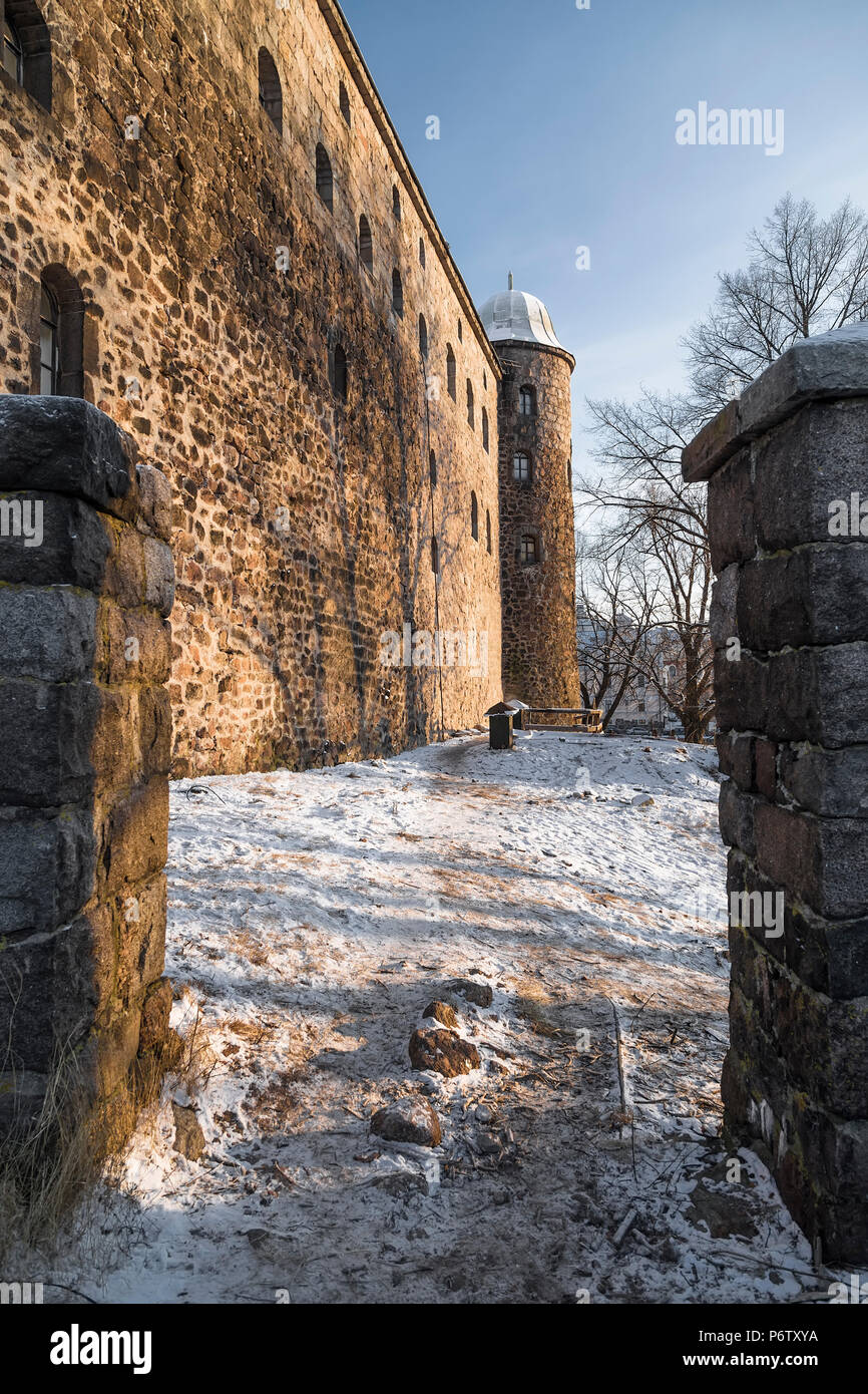Stone walls and a high fortress tower of the castle in the city of Vyborg. Russia Stock Photo