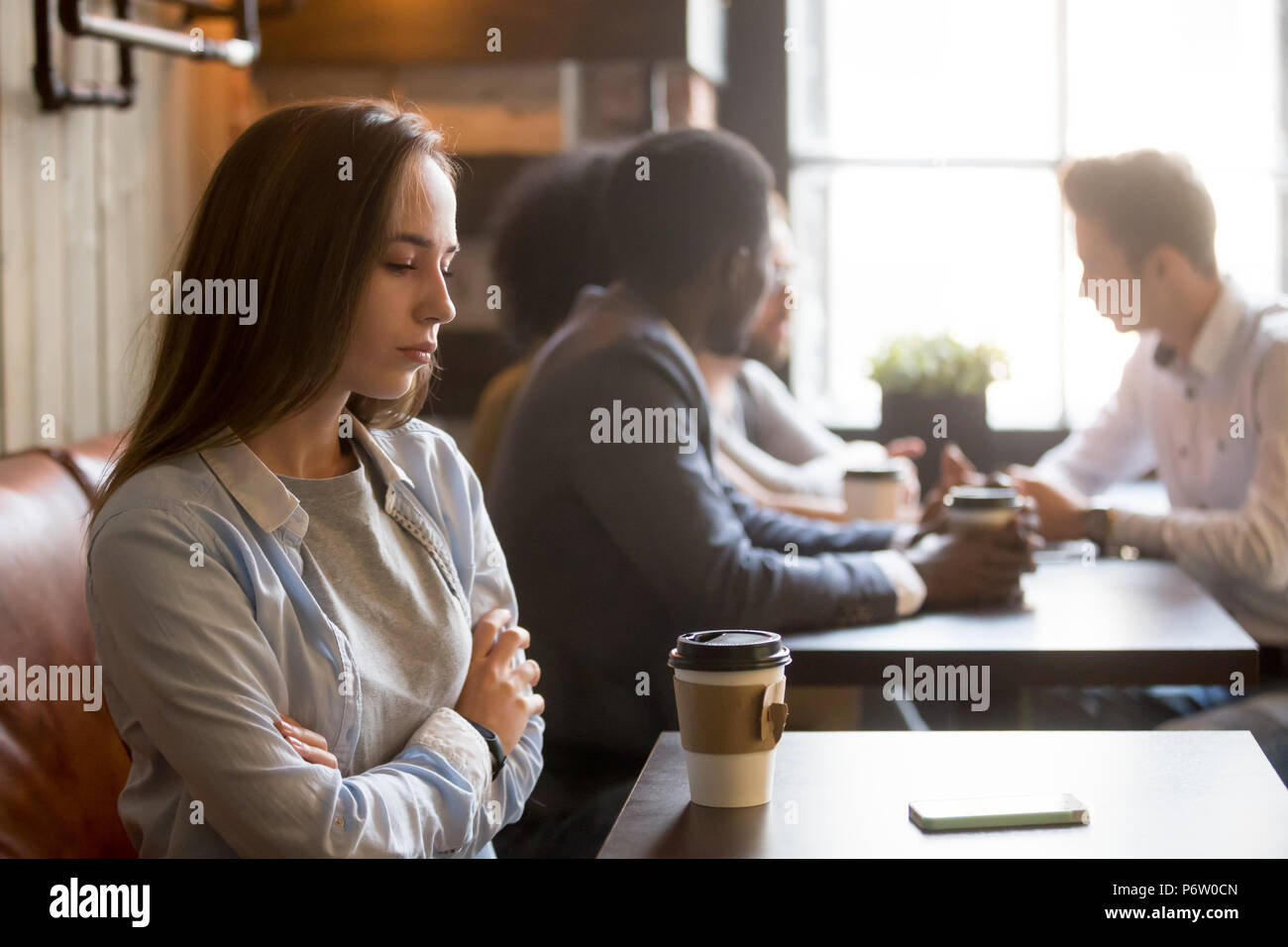 Upset rejected girl ghosted by boyfriend in coffeeshop Stock Photo